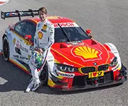 Red racecar with driver Shell logo on hood